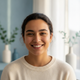 A candid portrait headshot of a smiling young adult with diverse features, looking content and trustworthy.